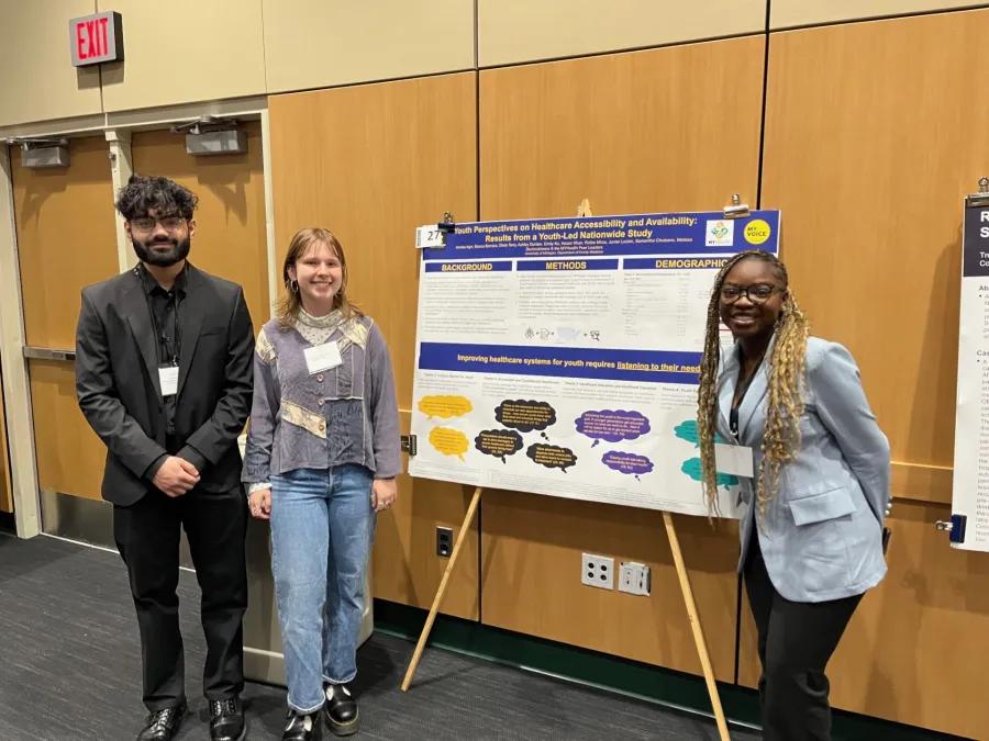 People standing by a poster presentation