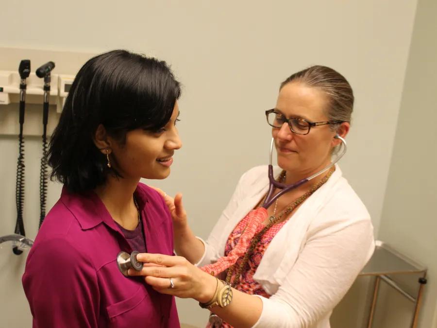 Doctor examines patient's heartbeat