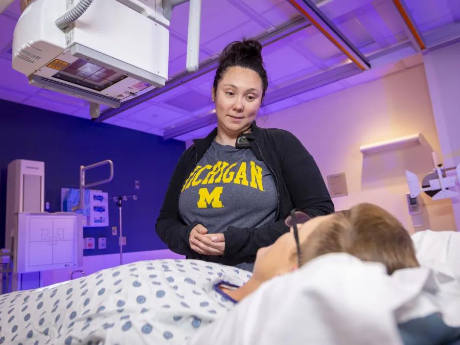 Female provider smiles at a male patient about to go through a scan