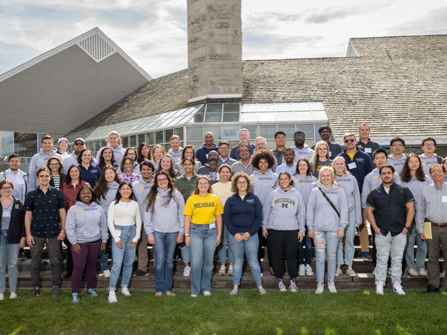 Researchers pose for group photo at outdoor retreat