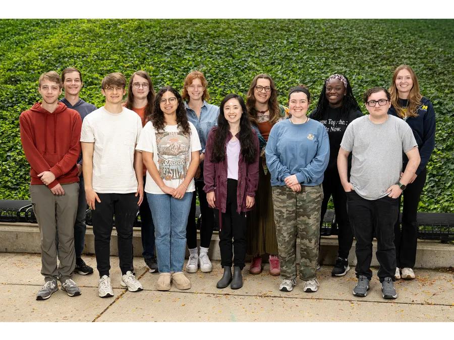 group of students in front of a green background