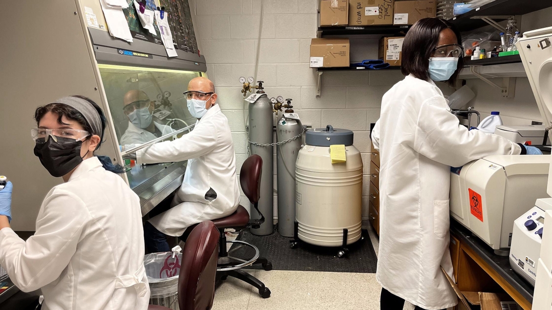 Students in Carruthers lab wearing lab coats