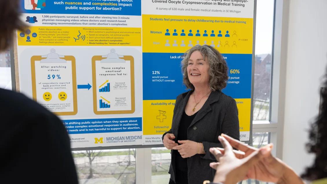  people listen to woman a while viewing content from obgyn posters from research day 