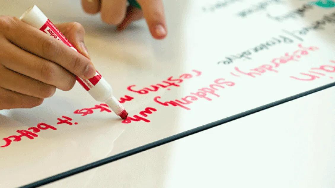 Writing with a marker on a white board
