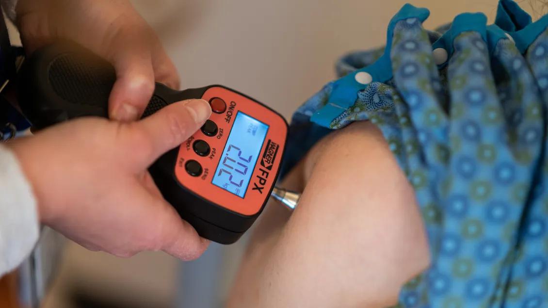 Device Is being held against arm to retain digital measurement 