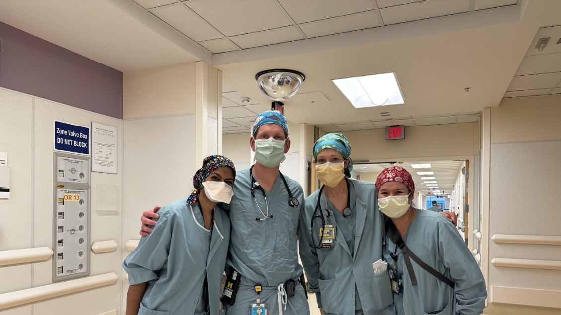 Group photo of anesthesiology nurses standing together in surgery hallway 