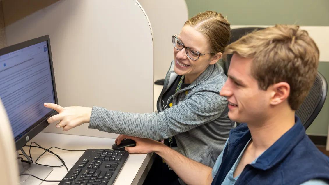 Doctor shows resident things to look at on the screen within the sleep movement disorder unit 
