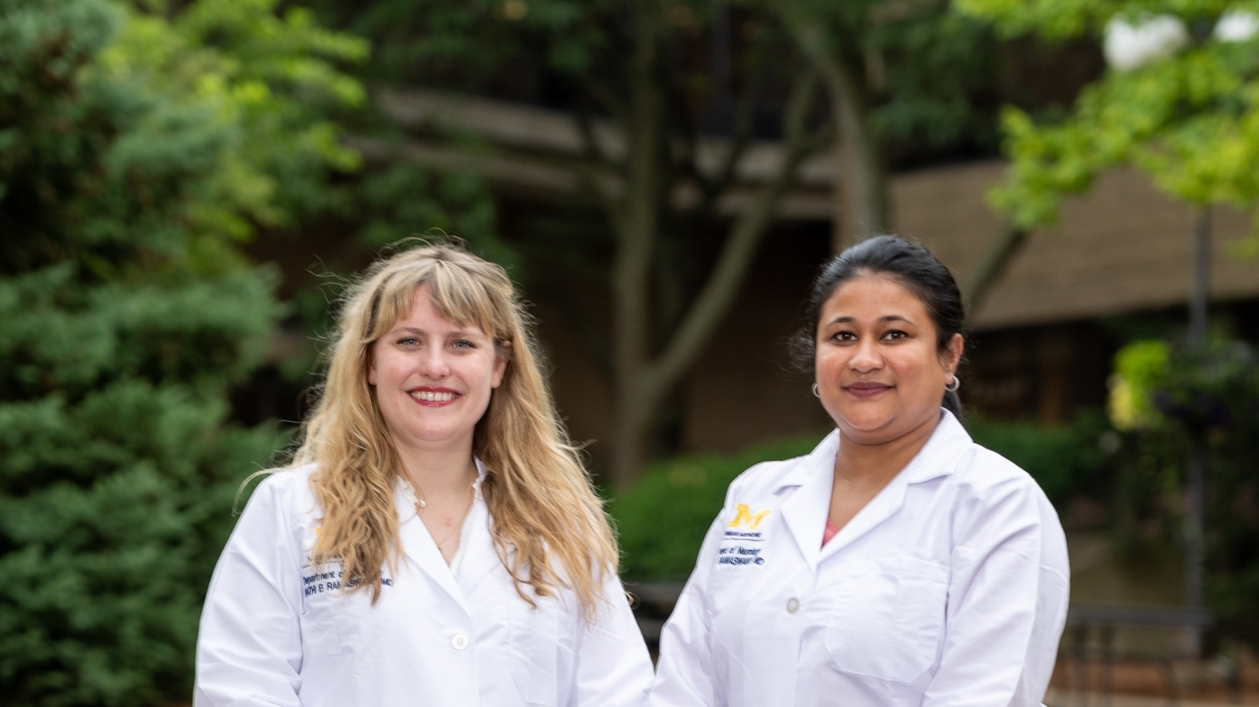 Two female neurology fellows stand together outside 