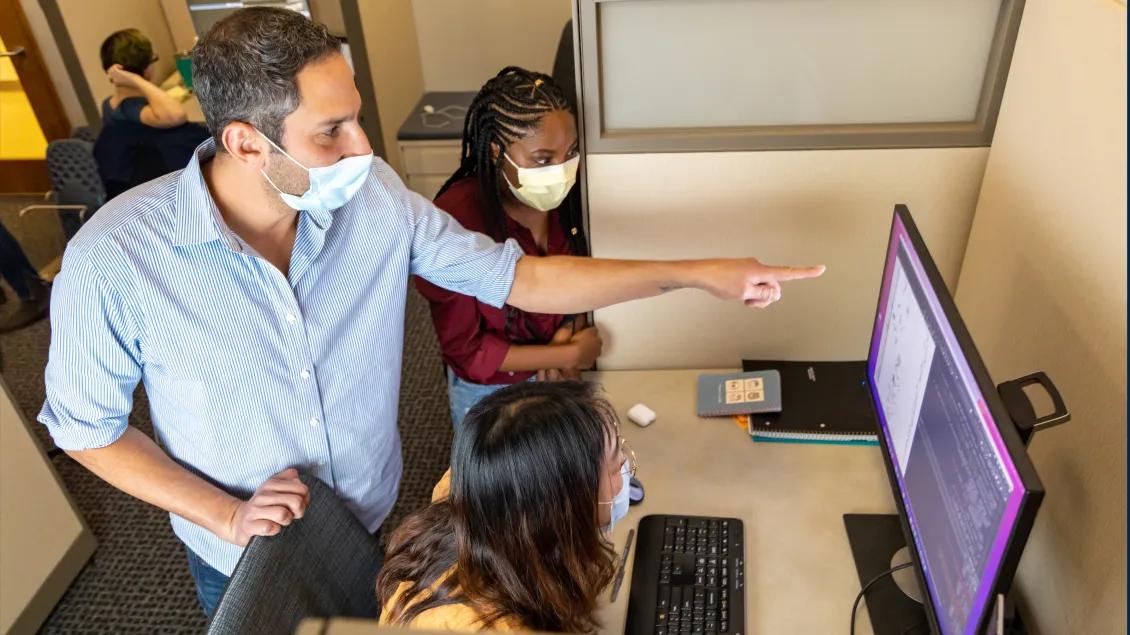 People working at a computer workstation