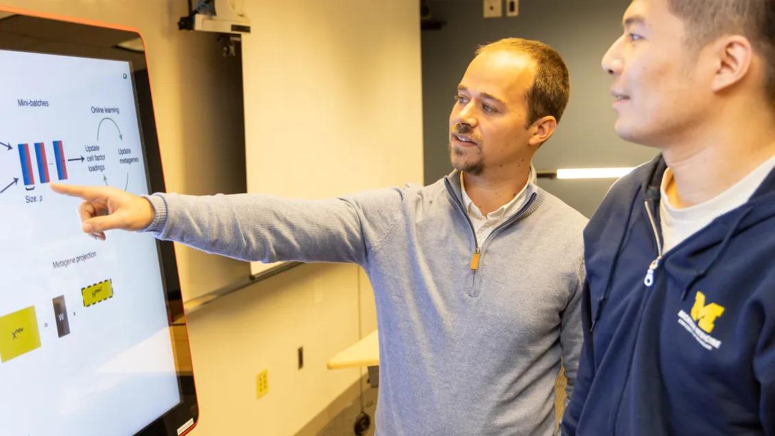 Two people reviewing data on a screen