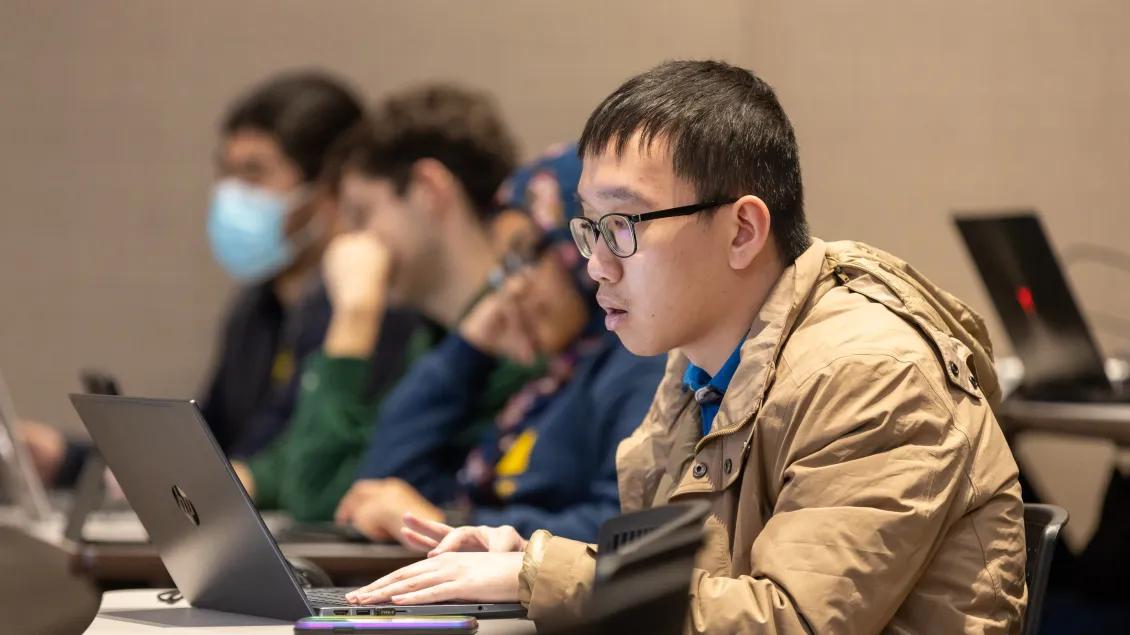 student looking on computer on mitrea lecture 