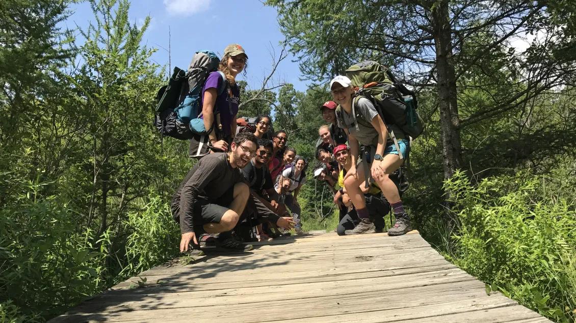 Students smiling walkway while camping