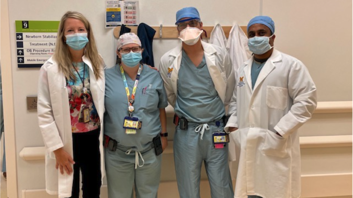 Four anesthesiologist standing together wearing masks and in scrubs 