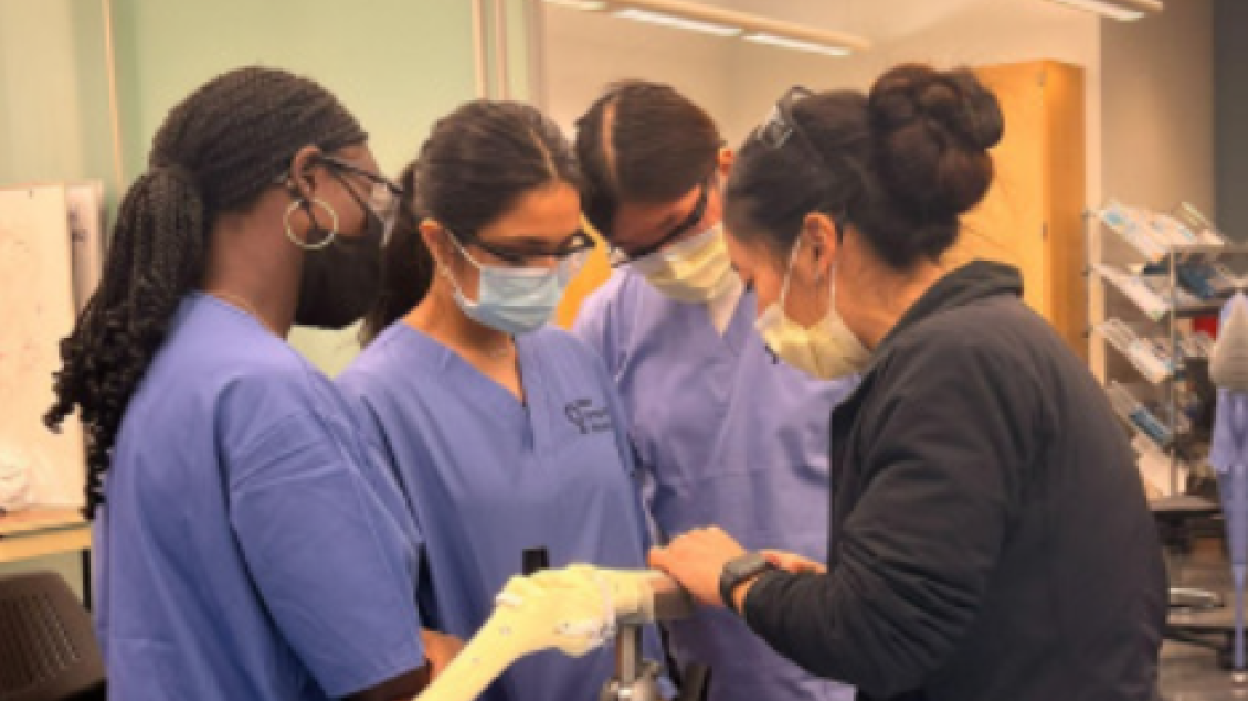 Orthopaedic Surgery students work together to examine a bone