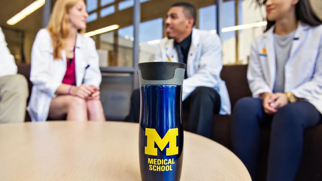 Providers having a conversation around table at hospital
