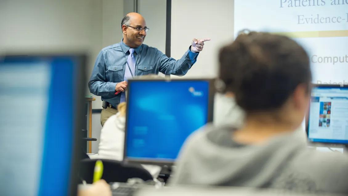 Instructor talking and pointing in a lecture