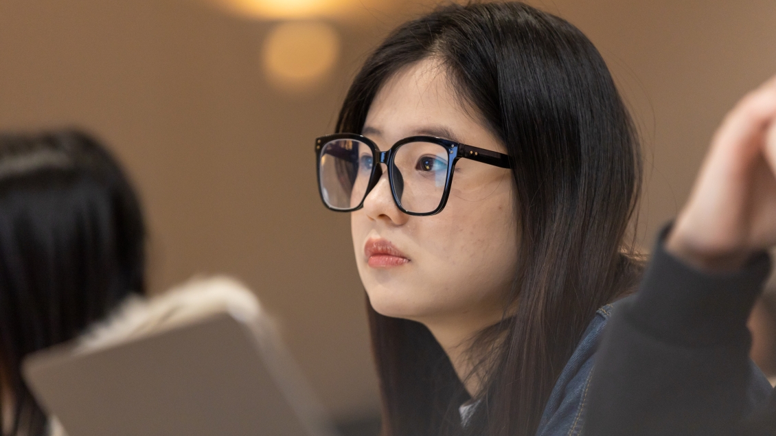 a person wearing glasses looking away