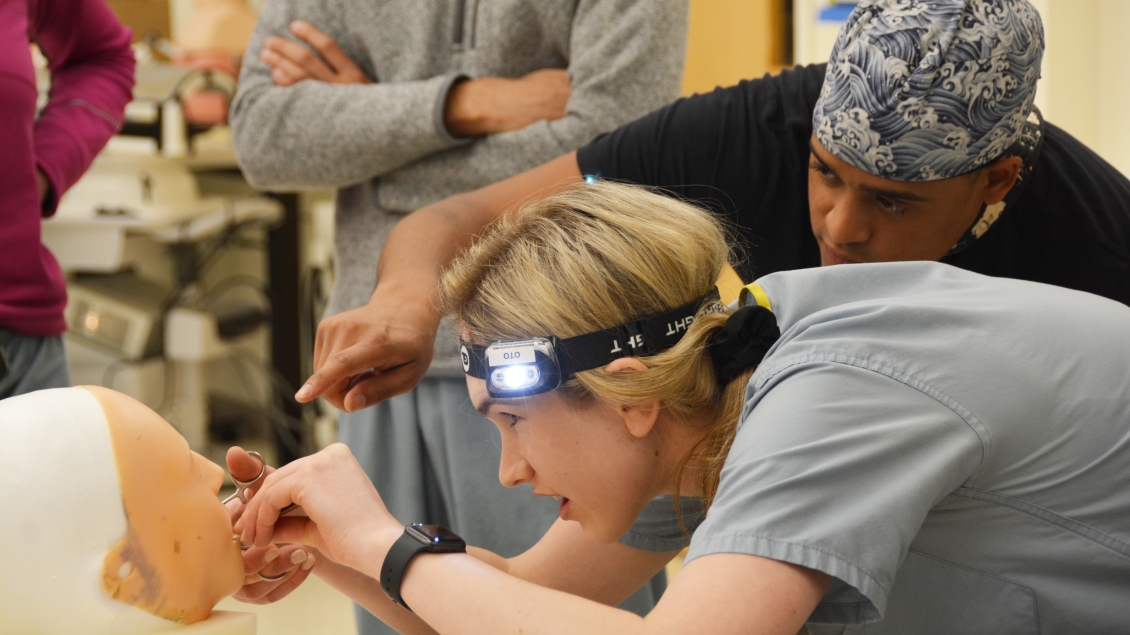 too student wears headlamp while training in a simulation 
