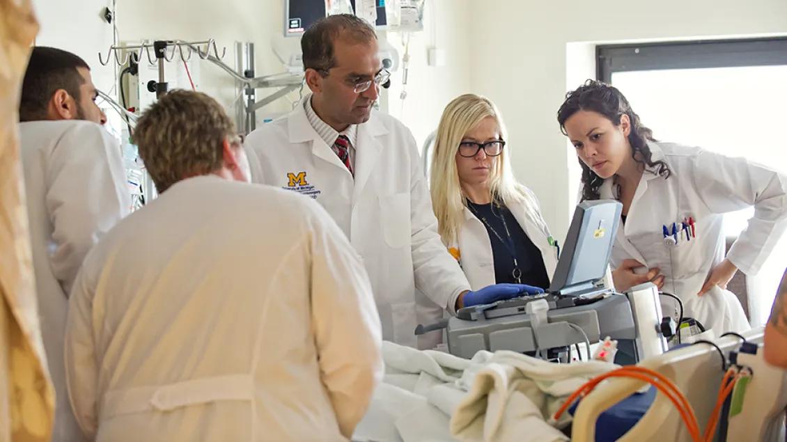 doctors look at an ultrasound on a patient