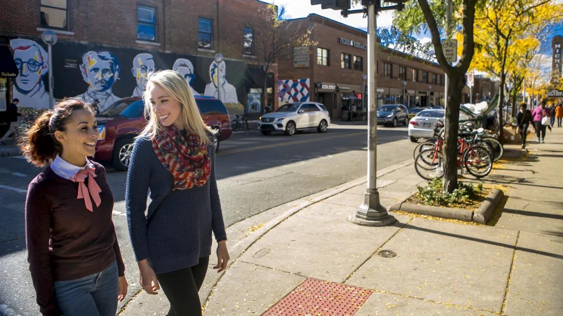 Two people walking on a city street