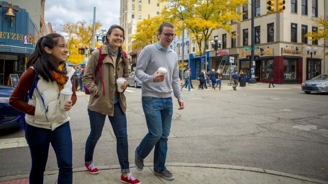 Three people walking in downtown Ann Arbor