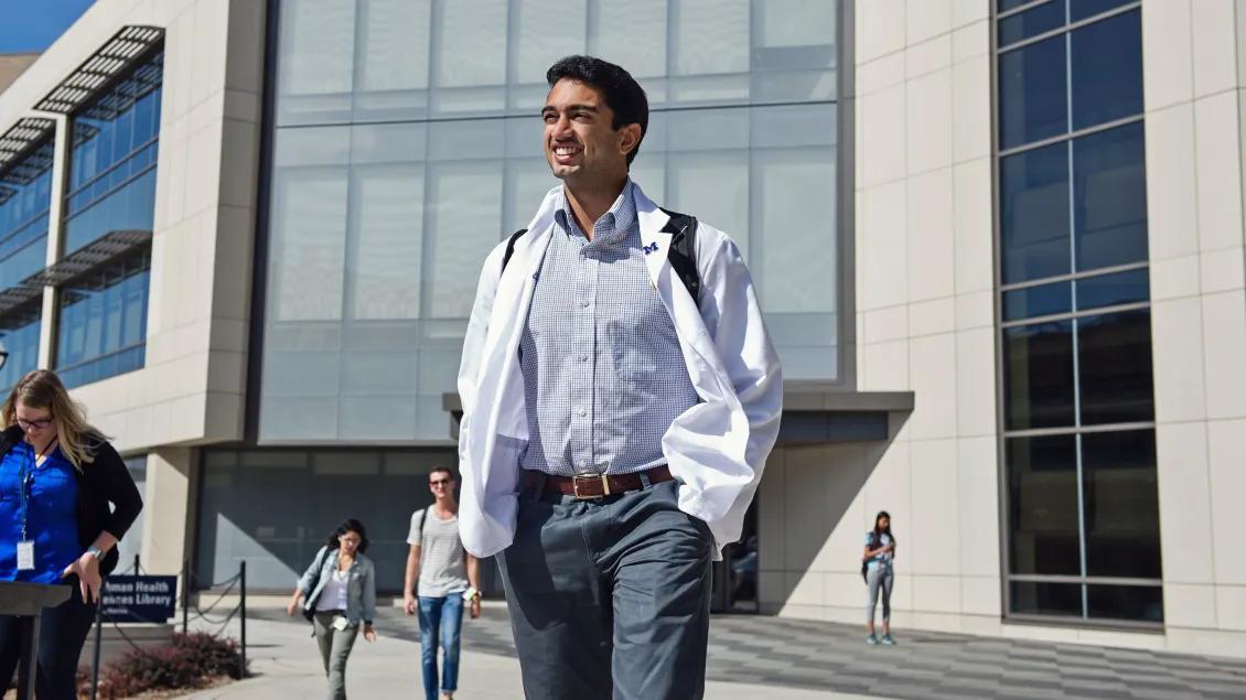 A person standing outside a campus building