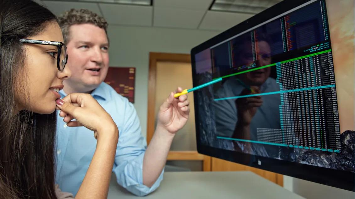 Two people looking at a computer screen