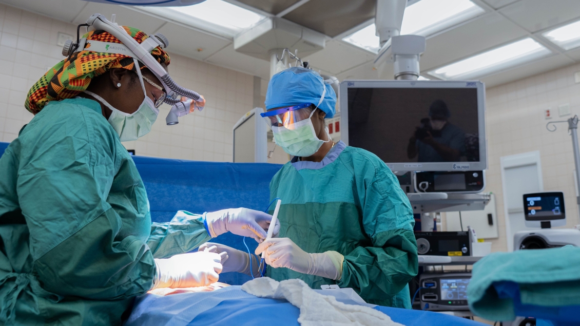 Two surgeons working in the operating room wearing masks