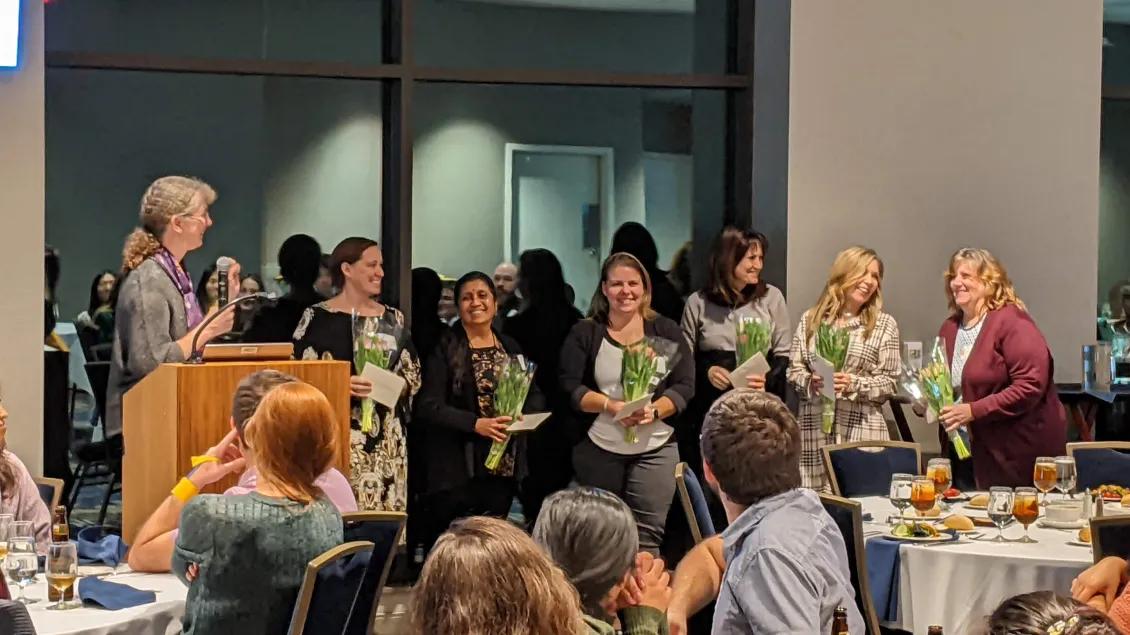 a group of women holding flowers