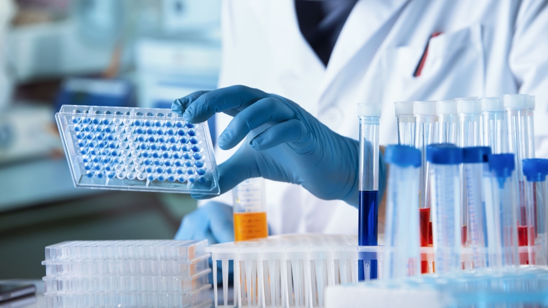 A researcher works in the lab with test tubes