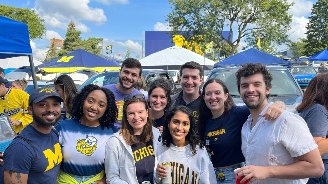 Anesthesiology residents smile at a Michigan football game