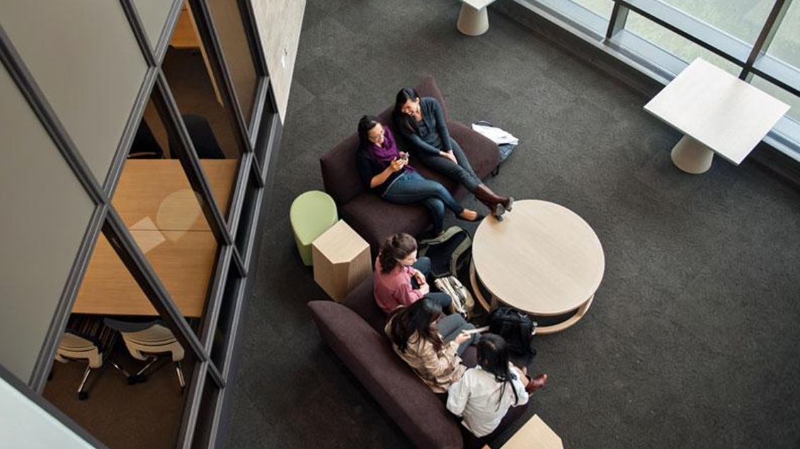 Overhead shot of students sitting at a lounge table