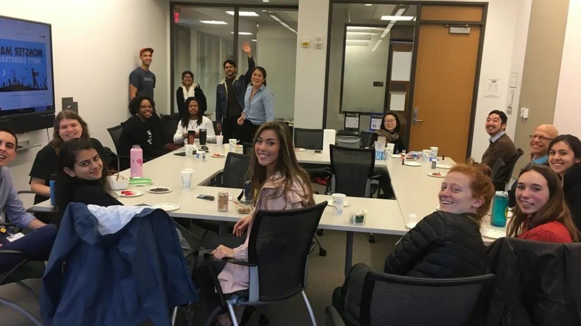 A group of people sitting around a table