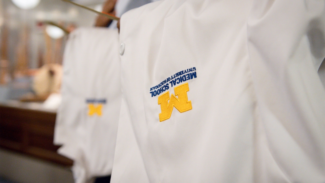 A set of Michigan Medicine lab coats