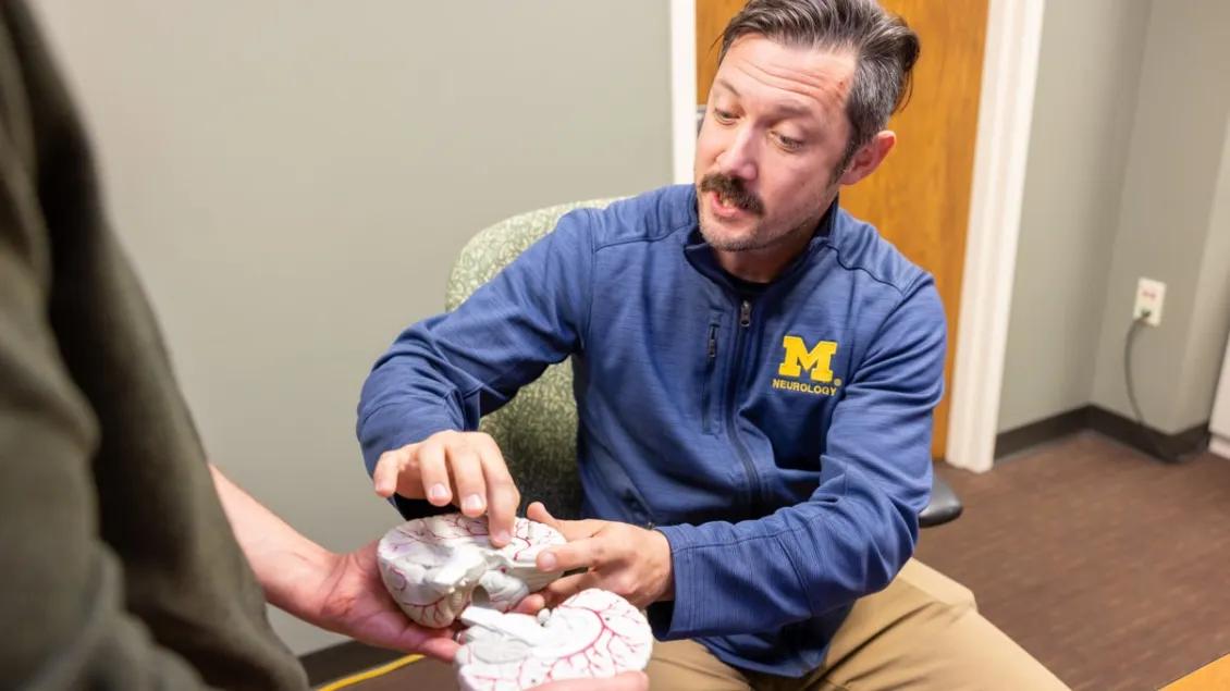 Chauncey Spears points to a model of a brain