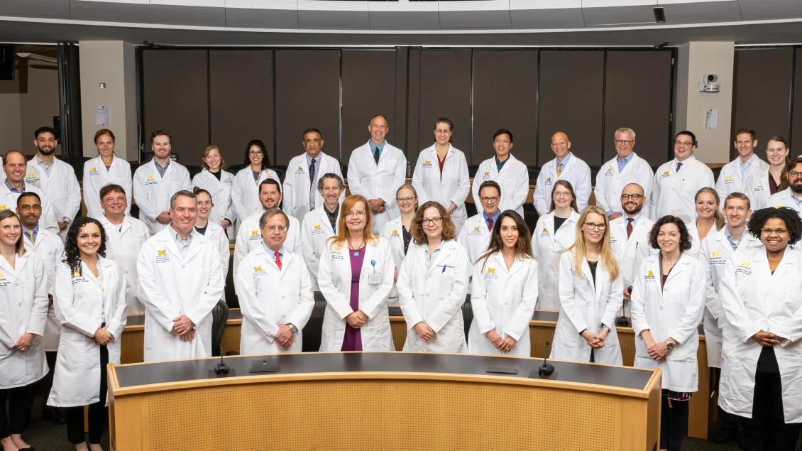 a group of people in white lab coats