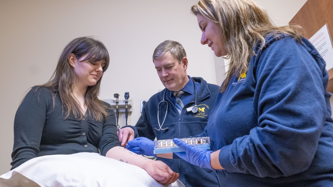 Woman gets allergy test done on her arm by two staffers