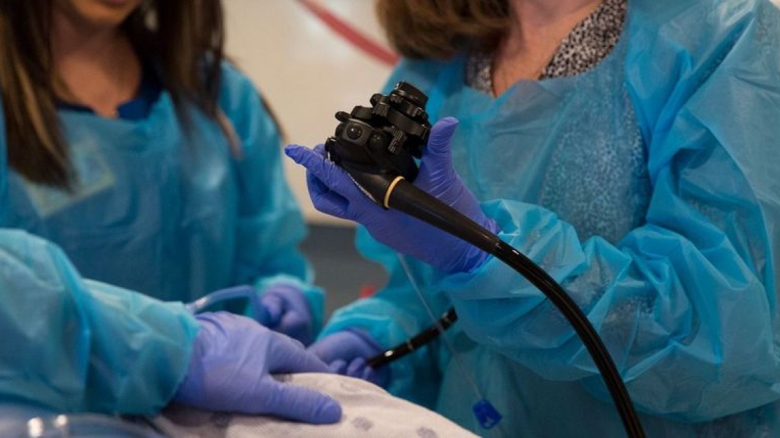 A close up photo of surgeons in the operating room using equipment