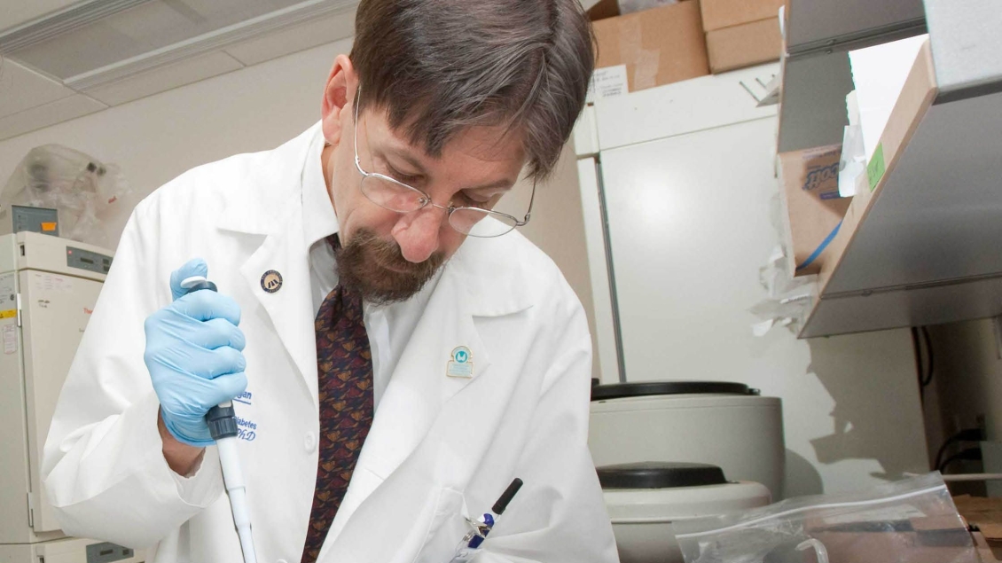 A researcher working with equipment