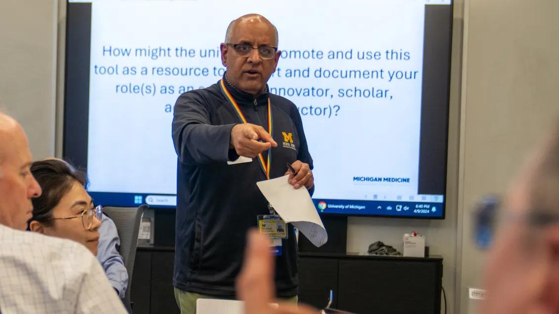 Raj speaking to a group of people