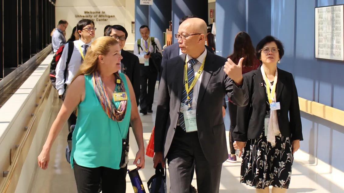 A group of people walking down a hallway
