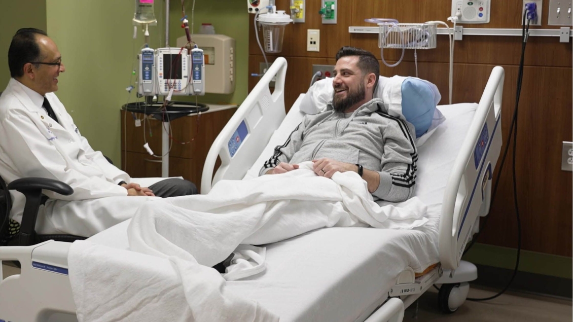 A patient in bed speaking with a doctor