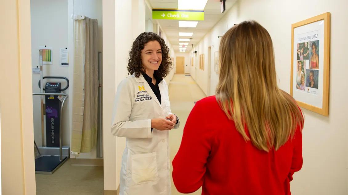doctor talking to patient in the hallway