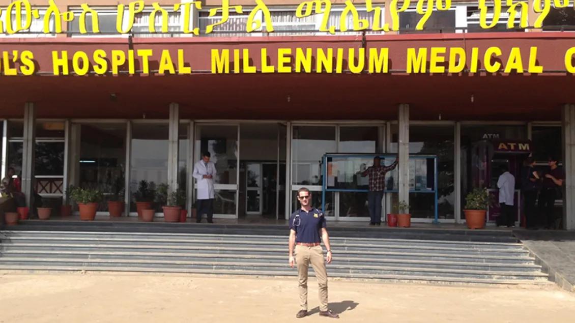 A person standing in front of St. Paul's hospital in Ethiopia