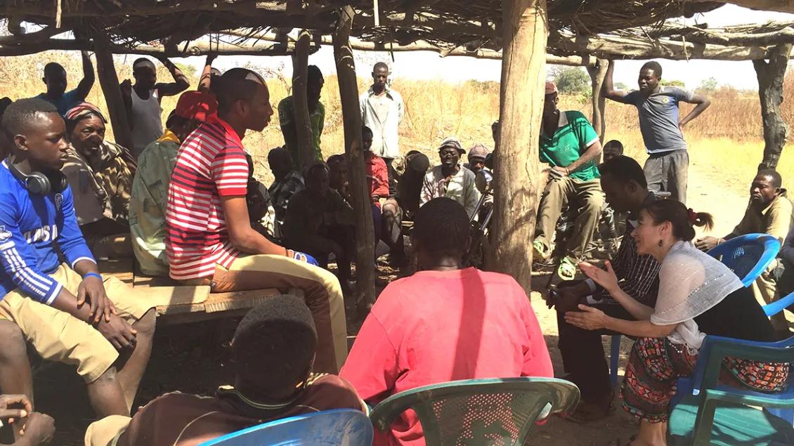 A group of people speaking together in Ghana