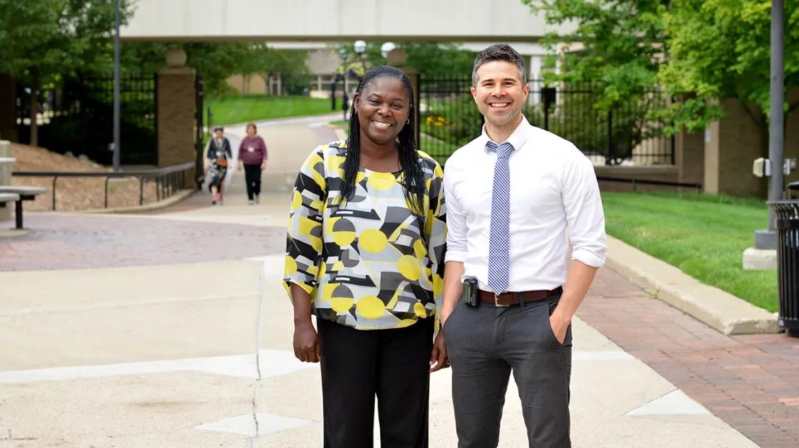Two people in front of a building outdoors