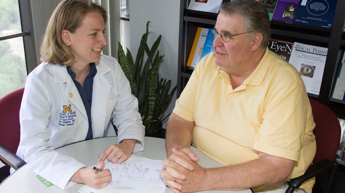 doctor talking to man in yellow shirt 