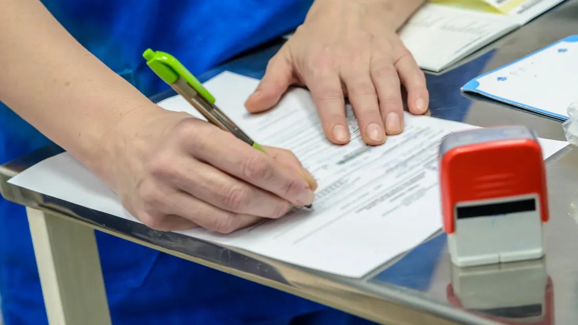 hands on paper writing with a pen