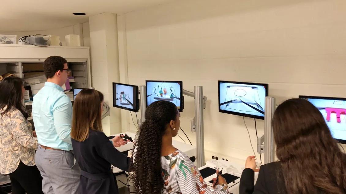 Students using tools to practice surgical techniques in the simulation center