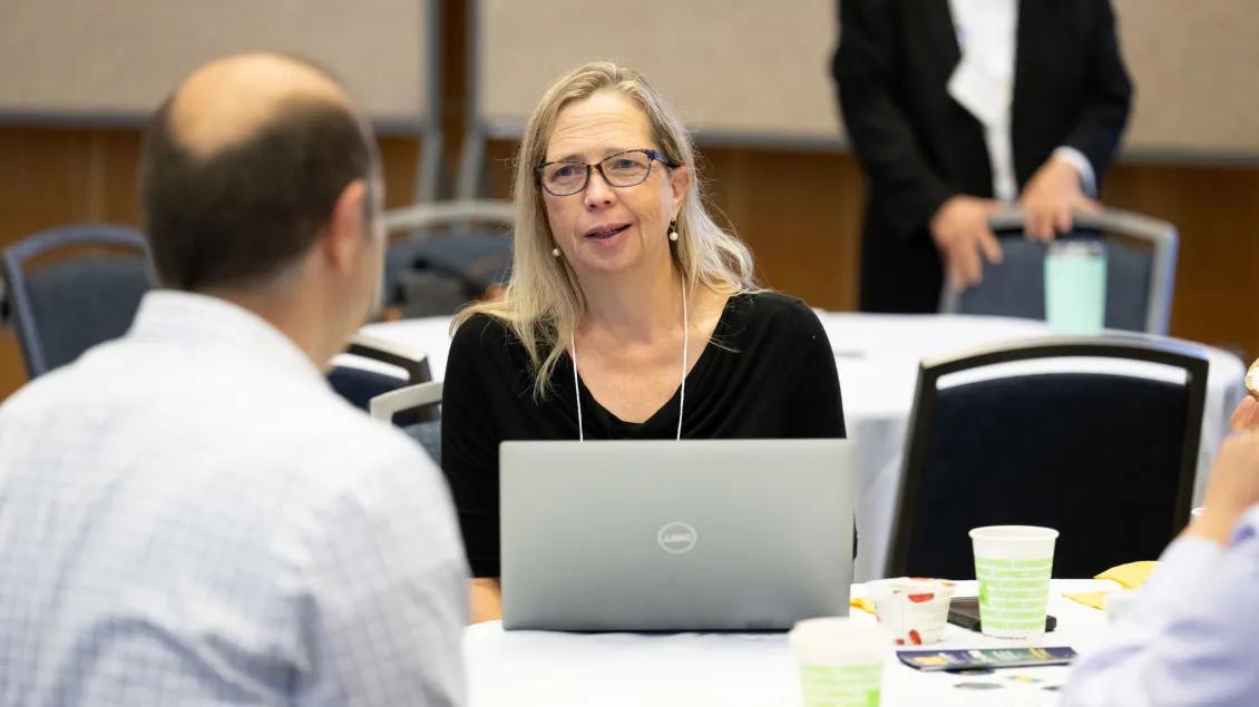 faculty talking to someone during a meeting or discussion